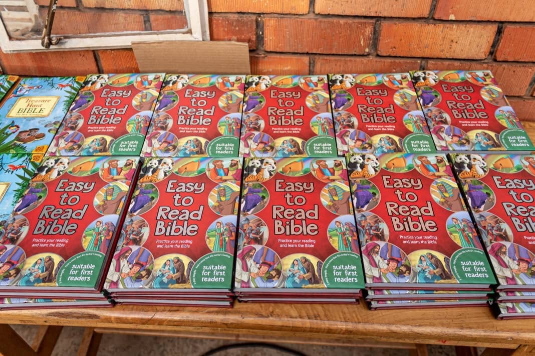 Stacks of Easy-to-Read Bibles for first readers, ready for distribution